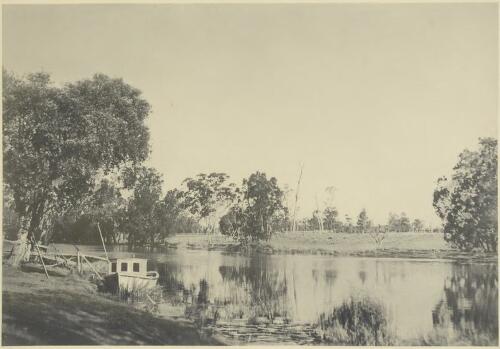 A cabin boat at the edge of a treelined river [picture] / H.D. Dircks