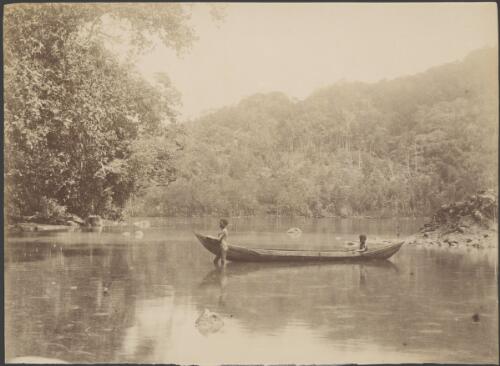 Two young Aboriginal men with a canoe in a river, New South Wales [picture] / Charles H. Kerry