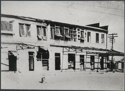 Gordon's Don Hotel, Cavenagh Street frontage, after a Japanese air-raid, Darwin, Northern Territory, ca. 1942 [picture] / reprinted by Bruce Howard