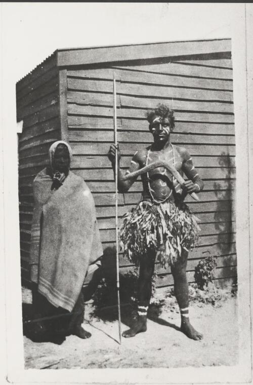 Indigenous man in traditional dress and a woman wrapped in a blanket, Cummeragunja Station, near Barmah, New South Wales, 1924 [picture] / Dennis Brabazon