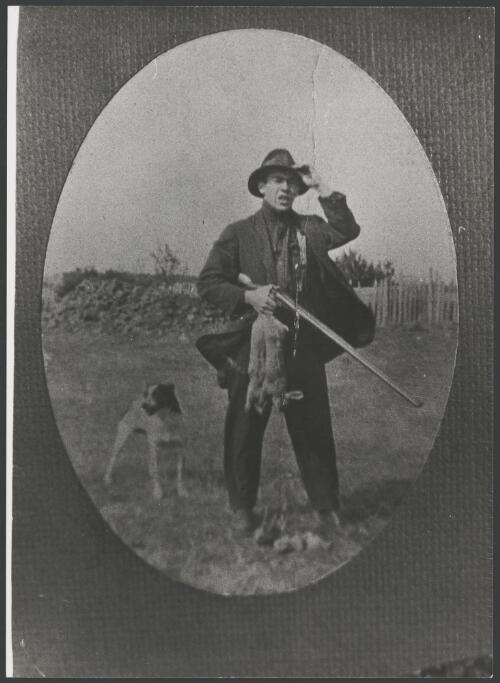 Man and dog hunting for rabbits and birds with a shotgun, ca. 1925 [picture]