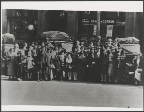People lining the street for a parade, Sydney, ca. 1930, 1 [picture]