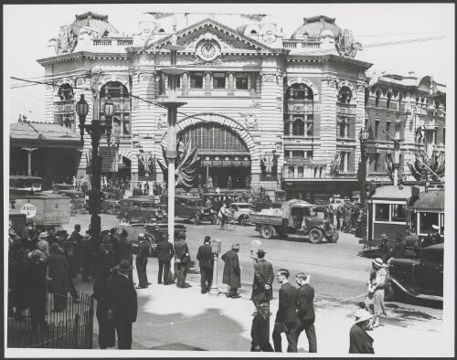 Street scene outside Flinders Street Station, which has been decorated with flags, Melbourne, ca. 1935, 2 [picture]