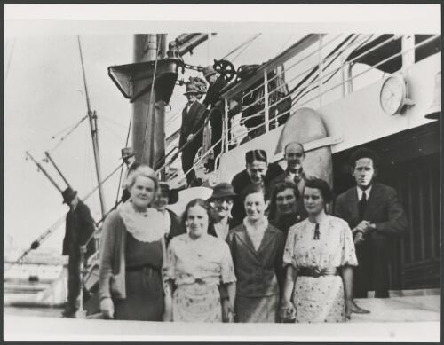 Group of people in front of a ship, ca. 1950 [picture]