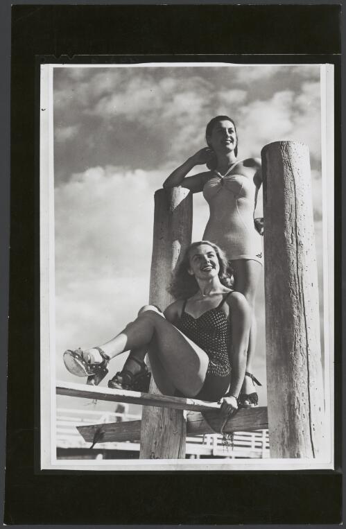 Two models wear Jantzen swimsuits at a jetty, ca. 1950 [picture]