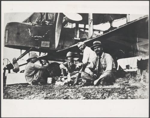 Captain Ross Smith and Lieutenant Keith Smith take lunch with two helpers during a fuel stop in the first flight from England to Australia at Charleville, Queensland, 1920 [picture]