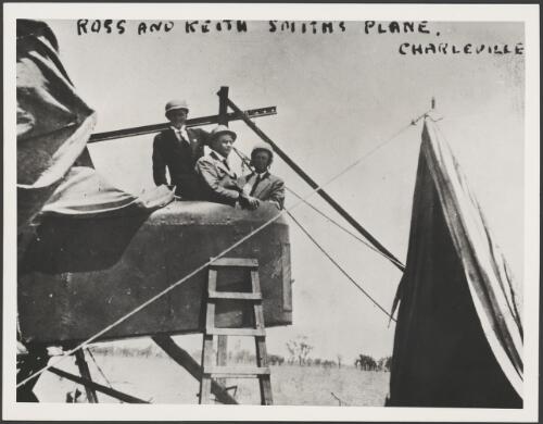 Workmen removing the engine from Ross and Keith Smith's plane for repairs in Charleville, Queensland, 1920 [picture]