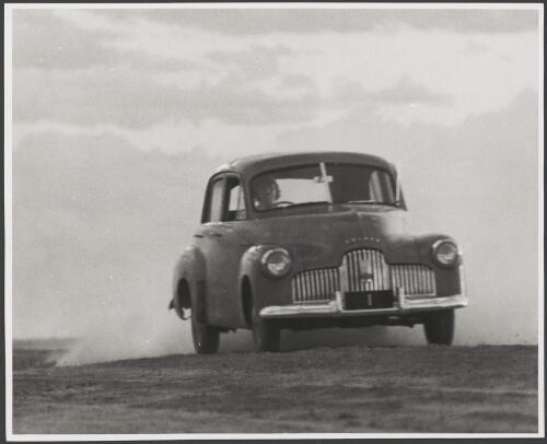 First Holden, being driven on a dirt surface, 1950 [picture]
