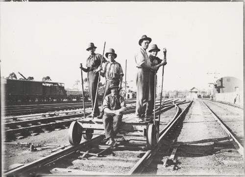 Railway workers on a trolley in the railway yards, Melbourne, ca. 1930 [picture]