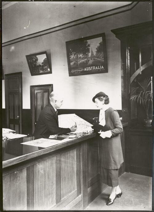 Customer receiving travel advice, Flinders Street Railway Station, Melbourne, ca. 1930 [picture]