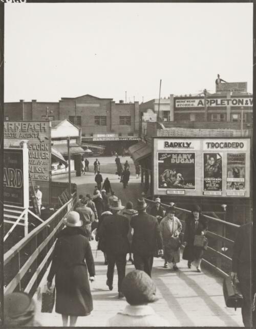 Billboards advertising films showing at the Barkly and Trocadero cinemas at the entrance to a railway station, Melbourne, ca. 1930 [picture]