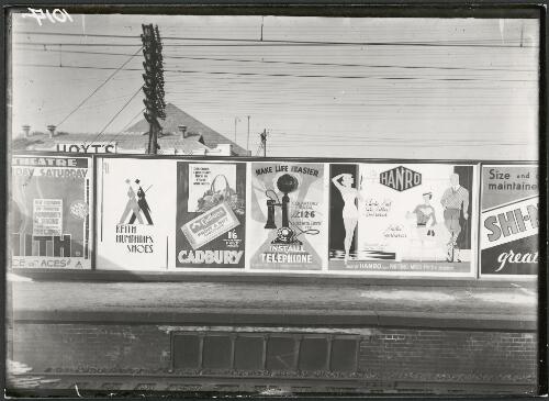 Advertising billboard for Keith Humphries shoes, Cadbury's chocolate, telephone installation, and Hanro knitwear on a railway platform, Melbourne, ca. 1930 [picture]