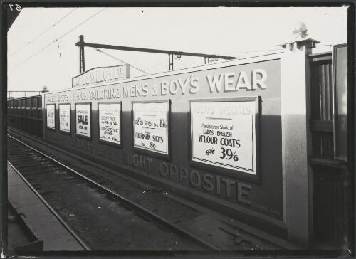 Advertising billboard for Ball and Welch Ltd drapery, tailoring and shoe shop beside railway track, Melbourne, ca. 1930 [picture]