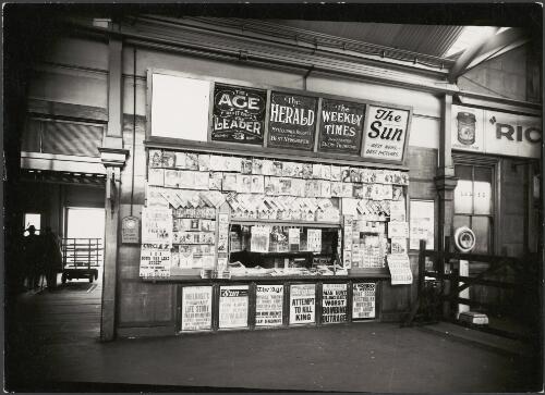 News stand in a railway station offering newspapers announcing the attempt on the life of King Edward VIII, Melbourne, 1936 [picture]