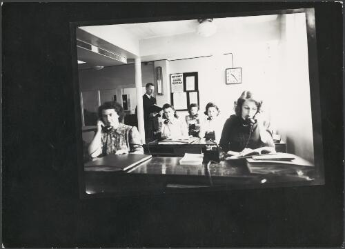 Women answering train information telephone enquiries at Government Tourist Bureau, Collins Street, Melbourne, ca. 1942 [picture]
