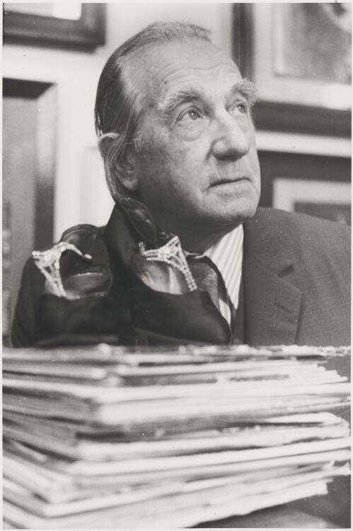 Portrait of Harry Woodward, the man in charge of Farmer's department store museum, with a pair of early twentieth century shoes from the collection, Sydney, ca. 1970 [picture]