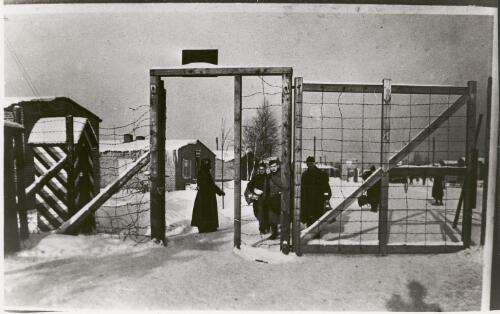 Group of prisoners of war carrying bags pass a guardhouse at Stalag Luft III, Germany, ca. 1943 [picture]