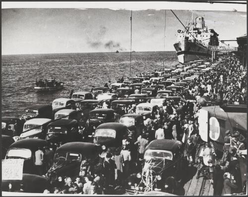 Dutch Hospital ship Oranje, carrying former prisoners of war, arrives from Singapore at Princes Pier, where the prisoners' relatives have parked their cars upon the pier so that the men would not have far to walk, Melbourne, 1 October 1945 [picture]