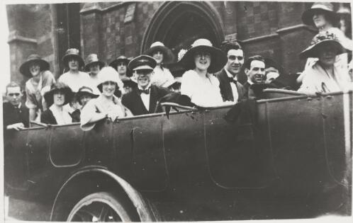 Office workers sitting in a Daimler hard wheeled charabanc outside St Paul's Cathedral on the way to an office picnic, Melbourne, 1922 [picture]