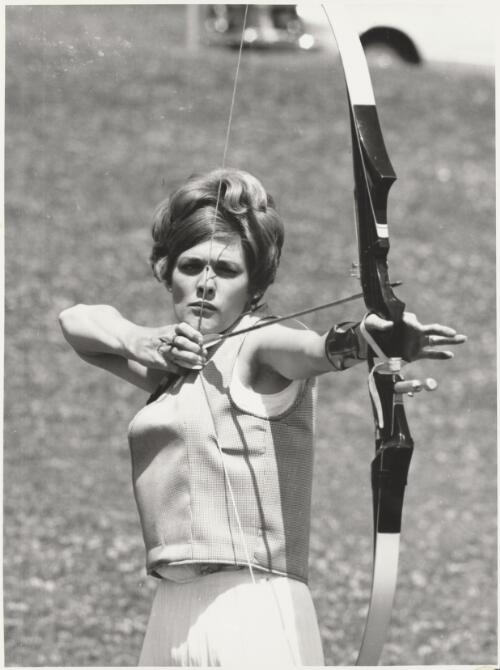 Drawing a long bow, Mrs P. Richardson at the Kew Golden Bow Archery Competition, Melbourne, Victoria, 1968 / Bruce Howard