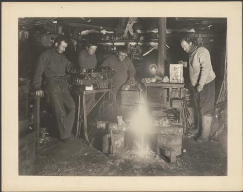 [In the workshop Bickerton, Correll, Hannam and Mawson (far right) welding a broken vice, Australasian Antarctic Expedition, 1911-1914] [picture] / Frank Hurley