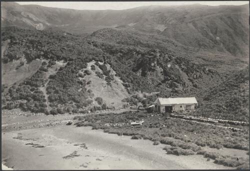 [View of hills and valleys with old hut in the foreground, Macquarie Island, Australasian Antarctic Expedition, 1911-1914] [picture] / Hamilton