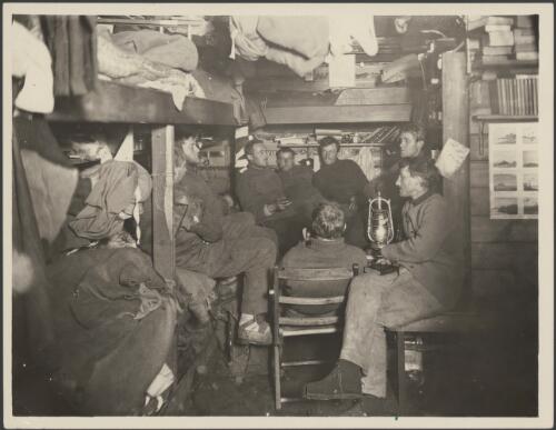 [Group discussion in the Main Base Hut, Cape Denison, Australasian Antarctic Expedition, 1911-1914] [picture]