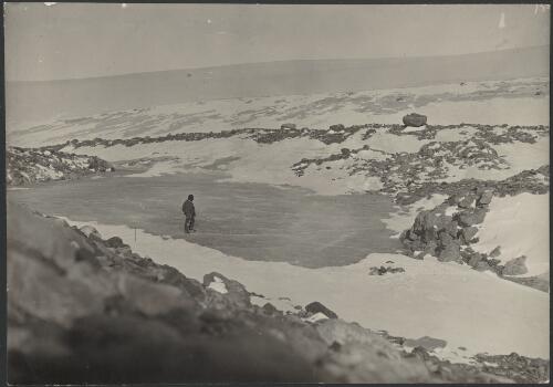 [Unidentified man standing on tidal patch looking across the landscape, Australasian Antarctic Expedition, 1911-1914] [picture] / Hurley