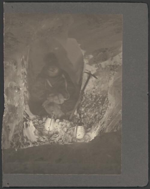 [Member of the expedition sitting in a tunnel, Australasian Antarctic Expedition, 1911-1914] [picture]