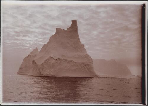 A keep of the ice solitudes: a turretted berg 210 feet high, [Australasian Antarctic Expedition, 1911-1914] [picture]/ Hurley
