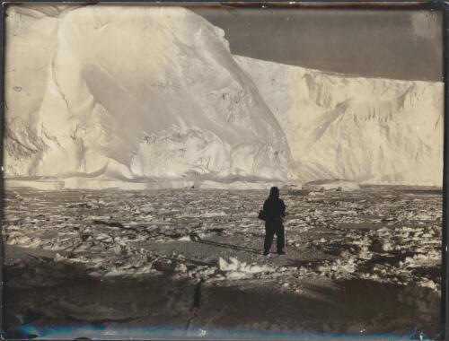 [Partly consolidated sea-ice below the ice cliffs west of Land's End, Commonwealth Bay. McLean in the foreground, Australasian Antarctic Expedition, 1911-1914] [picture] / Hurley
