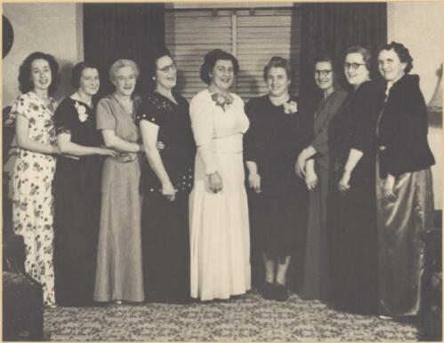 Elizabeth Dryer and Delia Murphy standing with a group of women, all wearing evening dress, Sydney, approximately 1948