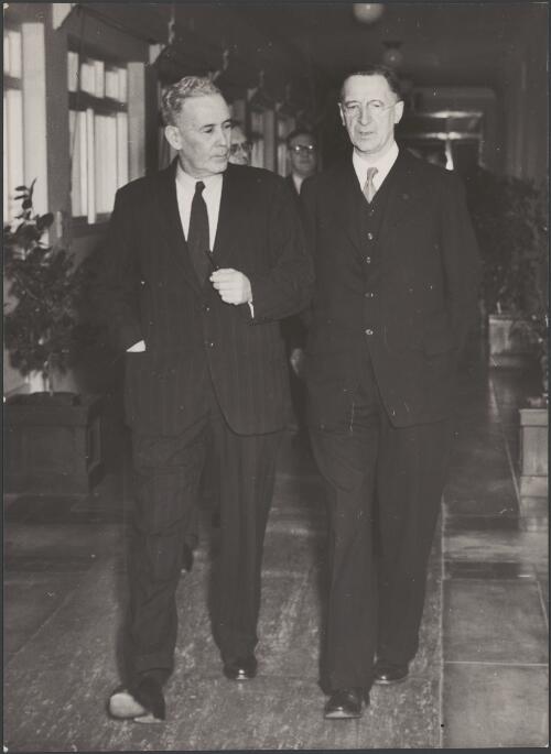 JB Chifley, Prime Minister of Australia, walking with Eamon De Valera, President of Ireland, with Arthur Calwell, Minister for Immigration, in the background at Parliament House, Canberra, 1948 / Department of Information