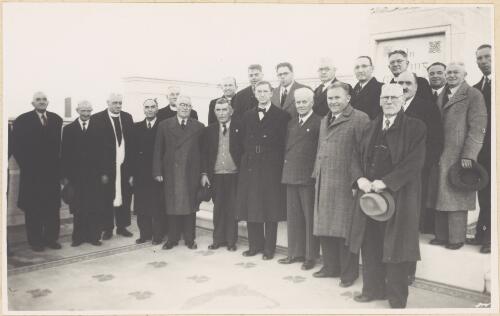 Eamon de Valera and Albert Dryer standing with a group of 19 other men at Irish Monument of 1798, Waverley Cemetery, Sydney, 1948