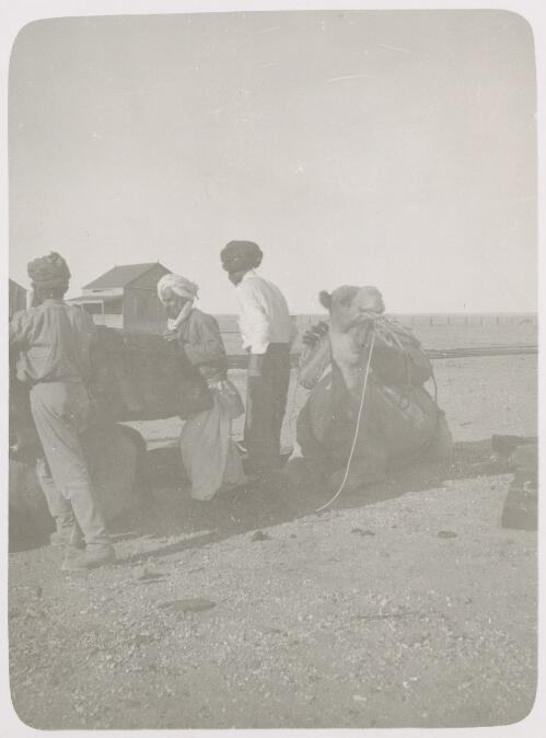 Three Afghans loading a camel, Bourke, New South Wales, ca. 1915 [picture]