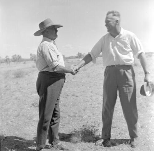 Tom Quilty shaking hands with Ike Livermore, Springvale Station, via Halls Creek, Kimberleys, Western Australia, 1956 [picture] / Frank H. Johnston