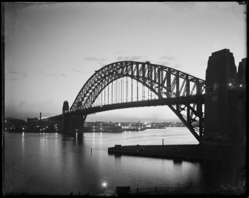 Sydney Harbour Bridge at night from Kirribilli, Sydney Harbour, ca. 1935, 2 [picture] / E.W. Searle