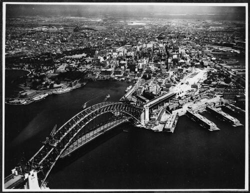 Aerial view of an incomplete Sydney Harbour Bridge from the north, Sydney Harbour, 1931, 2 [picture] / E.W. Searle