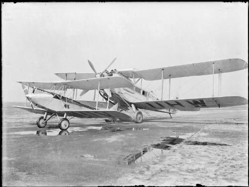 G-AUHW, a De Havilland 61 Giant Moth named Canberra, with a smaller aircraft G-AUIV, possibly an Avro Avian, Australia, ca. 1932 [picture] / E.W. Searle