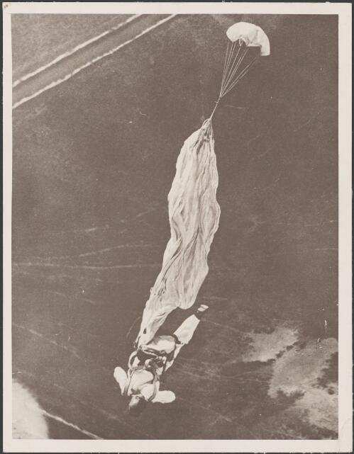 Viewed from an aircraft, a parachutist just as their parachute is deploying, Temora, New South Wales, ca. 1935 [picture] / E.W. Searle