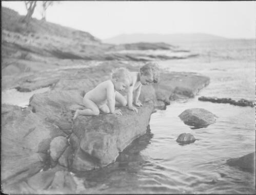 Allan and Dorian Searle looking into a rock pool, Kangaroo Bay, Bellerive, Tasmania, ca. 1915 [picture] / E.W. Searle
