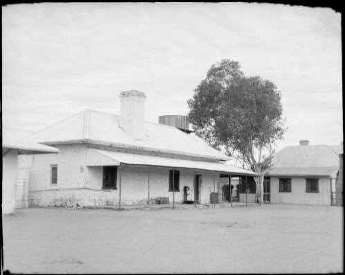 Building with elevated water tank behind, Northern Territory, 1947 [picture] / E.W. Searle