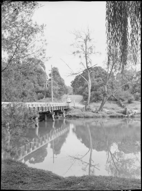 Austin A40 crossing a wooden bridge, Australia, ca. 1945 [picture] / E.W. Searle