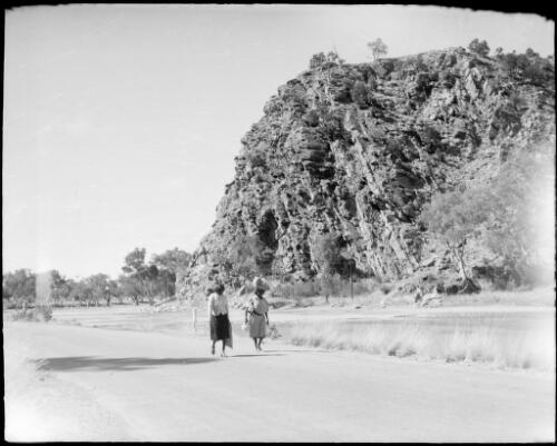 Two women walking through Heavitree Gap, Alice Springs, Northern Territory, 1947 [picture] / E.W. Searle