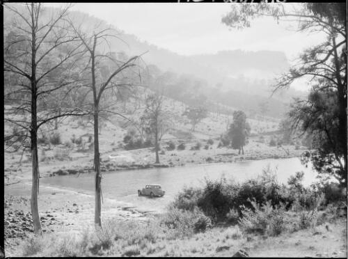E.W. Searle's Citroen stopped in mid stream, Barrallier Crossing, Wollondilly River, New South Wales, ca. 1945 [picture] / E.W. Searle