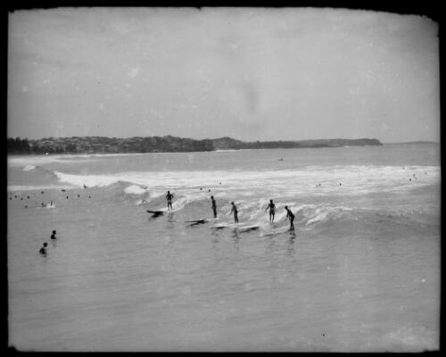 Five men riding surfboards, Manly, New South Wales, ca. 1939 [picture] / E.W. Searle