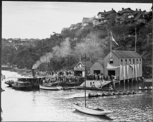 Rowing eights and a crowd of people outside the Mosman Bay Navy League and Sea Cadet Depot, Rowing Club, Mosman Bay, Sydney Harbour, ca. 1927 [picture] / E.W. Searle
