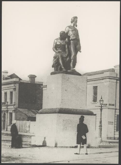 Man and woman near Burke and Wills monument, Corner of Collins and Russell Street, Melbourne, ca. 1890s [picture]