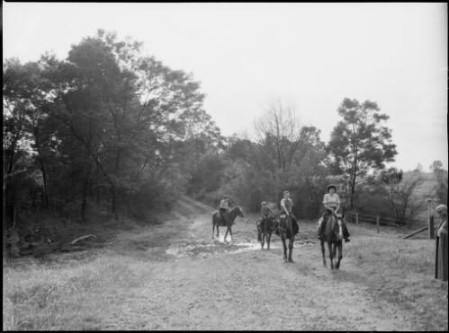 Four people on horseback, Australia, ca. 1945 [picture] / E.W. Searle