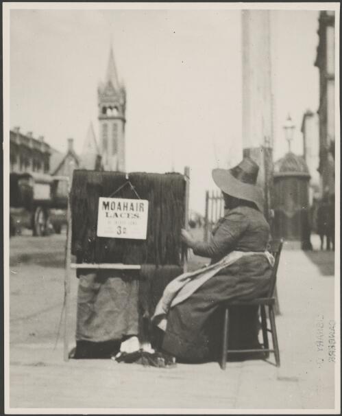 Seated woman selling mohair laces in a Melbourne street, Melbourne, ca. 1902 [picture] / E.W. Searle